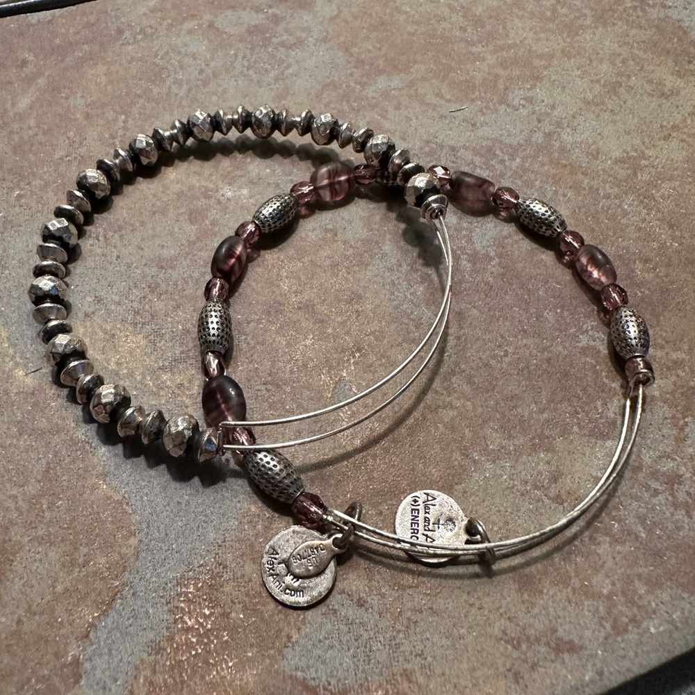 Two Alex and Ani silver bracelets. One has amethyst beading.